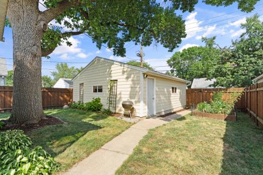 Fully fenced yard includes raised garden beds