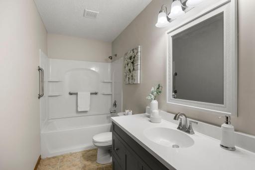 All three bedrooms are conveniently located near the shared full bathroom, complete with a large new single vanity, tub/shower combination, and a linen cabinet just outside in the hallway for additional storage.