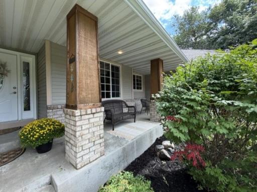 Inviting front porch area for a set of chairs and a table to enjoy beverages on nice summer days