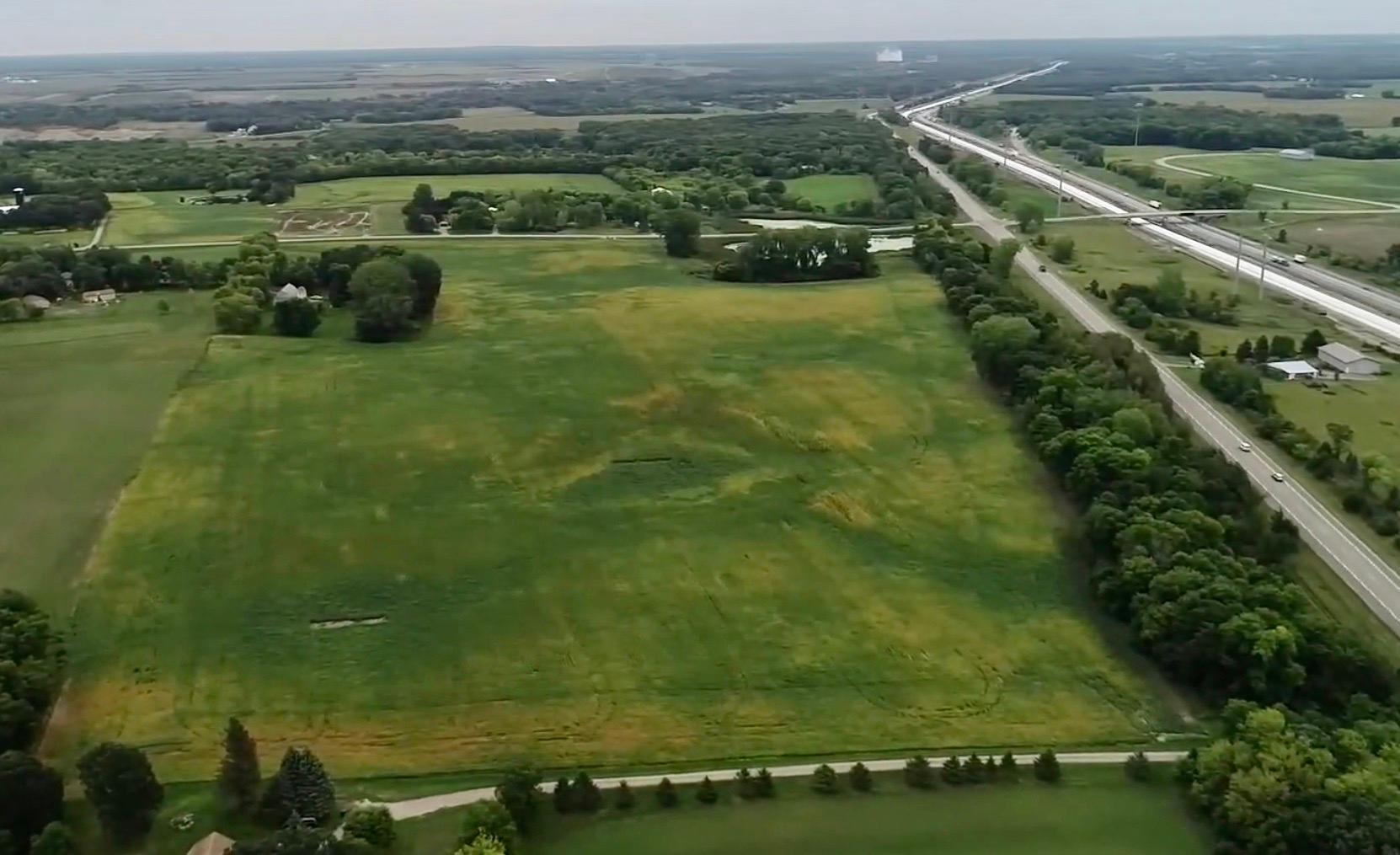 Subject property in the foreground looking east toward Monticello. Neighbors driveway roughly defines its west boundary. CR 75 and I-94 shown on the right side of frame.