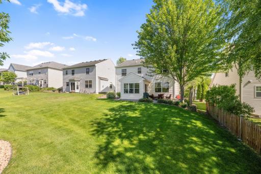 Enjoy your large, flat back yard with mature trees and landscaping.