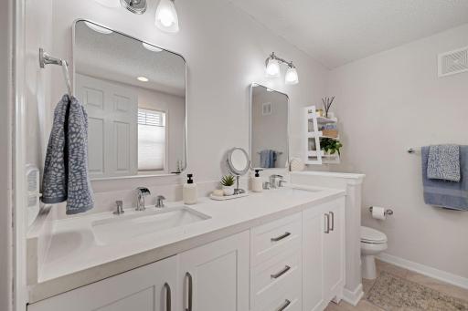 Dual vanities, separate walk-in shower stall & jetted tub.