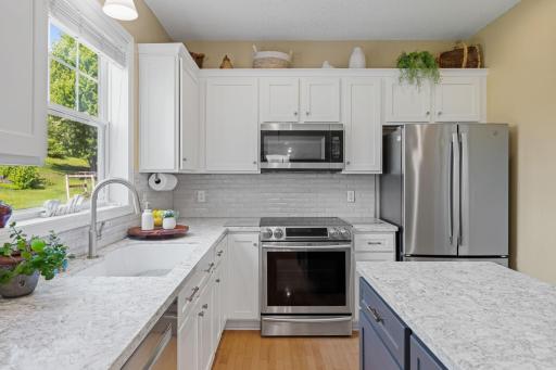 Walk-in pantry & a center island with pull-outs make this kitchen as functional as it is gorgeous.