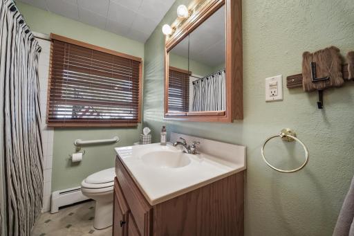 Main level bathroom with tub and shower