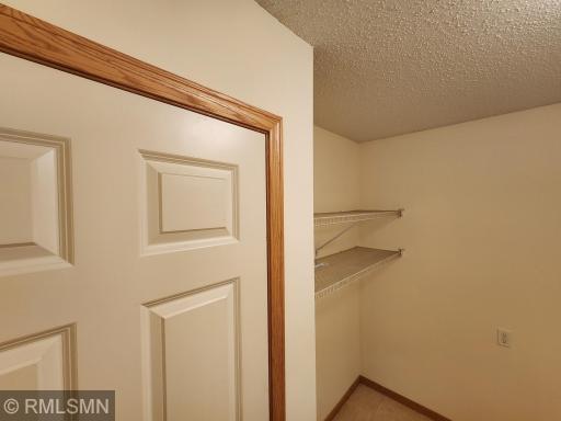 Large upper level laundry nice area with shelving for for storage