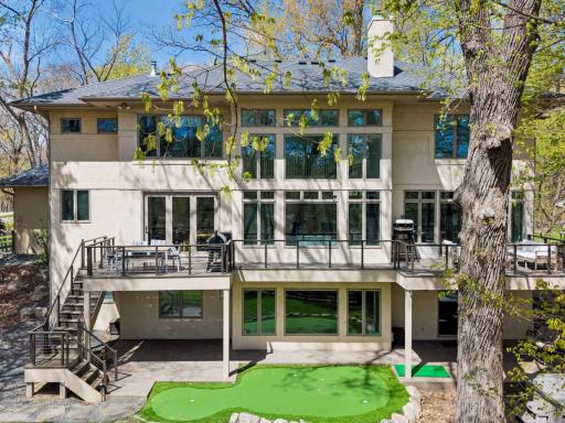 Rear exterior of the property - complete with hot tub and private putting green.