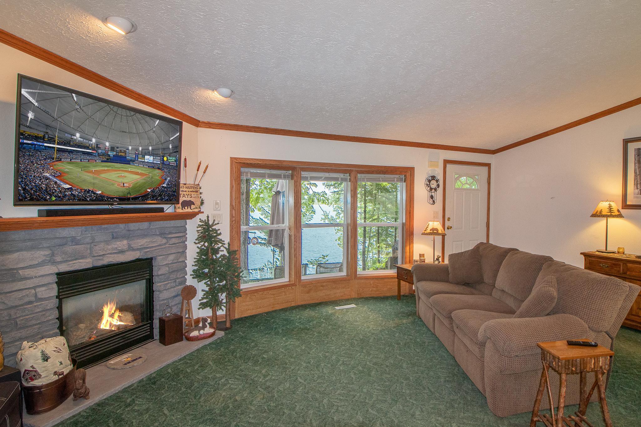 Lakeside views in living area with entry to outside deck