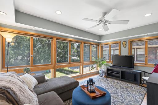 4-season sunroom features 3 walls of windows.