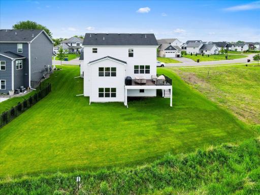 Move-in ready with large composite deck with waterproofing, in-ground sprinklers, and gutters