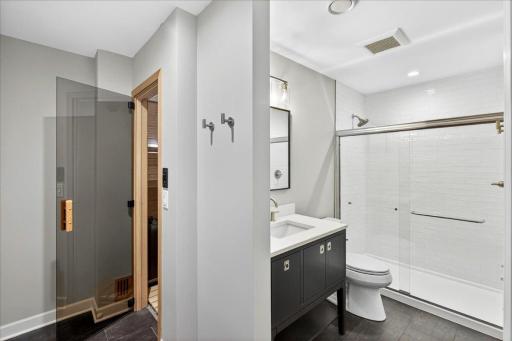 Finished basement bathroom with tile shower and beautiful brand new sauna.