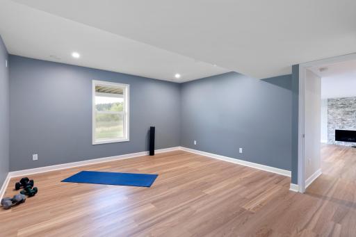 The fifth bedroom is downstairs, and is currently used as an exercise room with luxury vinyl flooring.