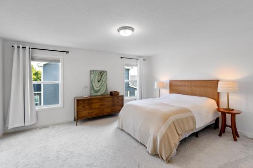 Primary bedroom with custom top-down window treatments for privacy and light