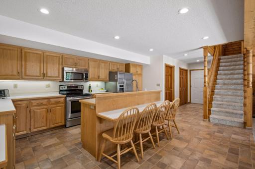 Kitchen has adjacent storage, big coat closet and access to the attached garage.