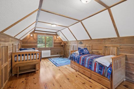 Bedroom #4 over the garage has two double casement windows, hardwood floors and a minisplit for zoned heating/cooling.