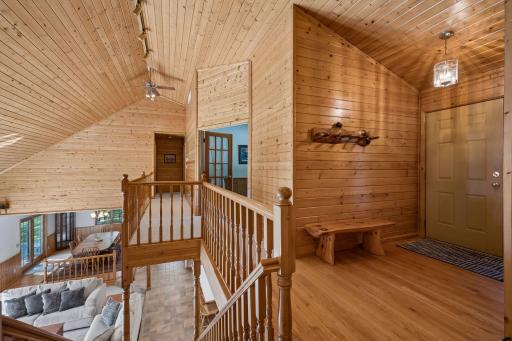 Spacious wood entryway is warm and welcoming