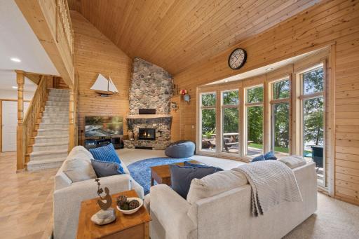 Floor to ceiling stone fireplace with effecient Kozy heat wood burning insert will take the chill off in winter