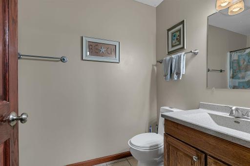 3/4 bath off of the laundry room and kitchen area. Offering updated vanity, sink, and toilet.