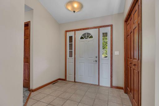 Large open welcoming foyer offering tile floors and large coat closet. Beautiful woodwork and six panel doors throughout the home!