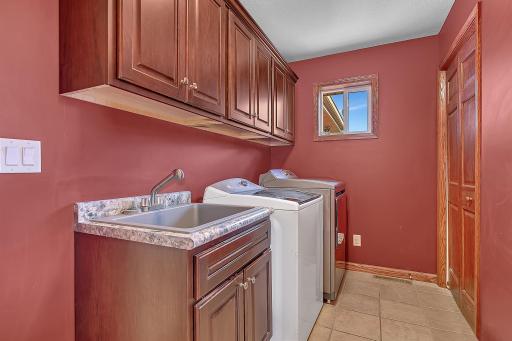 Laundry room with garage access located off of the kitchen. This space also has tile floors and offers access to another main level 3/4 bath.
