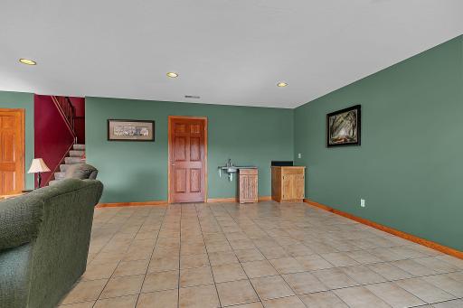 View of the family room area from the patio door. There is a wet bar- bring your idea and complete this area for your own entertaining space.