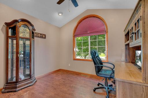 Second main level bedroom with vaulted ceilings and can lighting currently used as an office. Great bedroom with updated engineered wood floor.