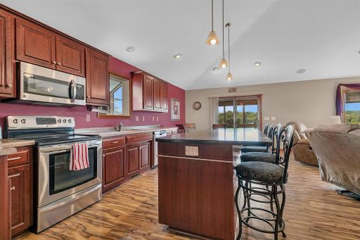 View of the kitchen and dining area which leads to the screened in deck.