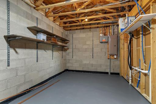 Lower level large storage area. There is also a separate utility room offering even more storage.