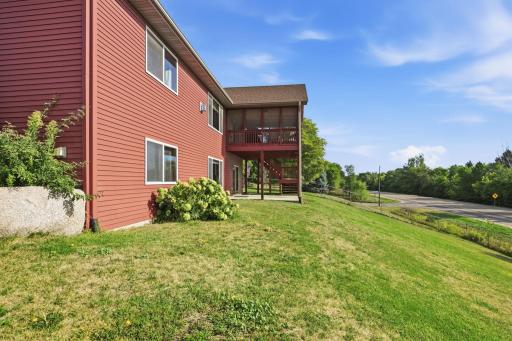 View of the home showing the covered screened deck and patio area. Come enjoy all this home has to offer.