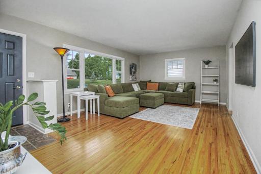 Huge Living Room w/ gleaming original hardwood floors throughout.