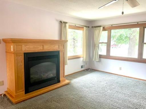 The Main Level Living Room with Gas Fireplace and Corner Windows for Abundant Natural Light.
