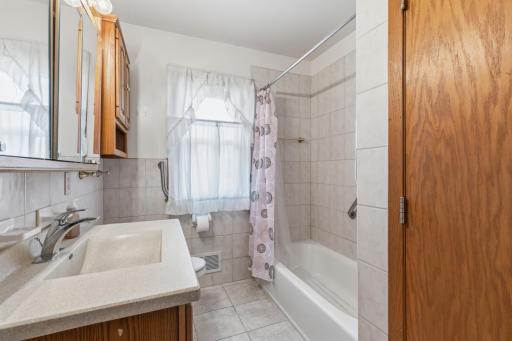 Wide Main Full Level Bath with Tile Floors and Shower Walls. No '70s Retro Here!