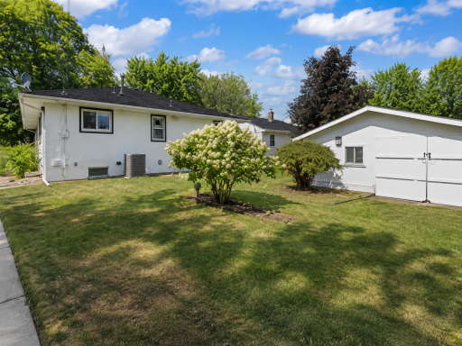 The Back Yard Features a Large 14x9 ft Storage Shed with a 6 ft Ceiling and 80-inch Wide Door for Easy Access to Lawn Accessories and Garden Tools.