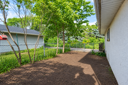 ...or Use This 29 ft Deep x 14 ft Wide Fenced Area to the Right of the Garage for Your Boat or Trailer, for a Garden or for Pets.