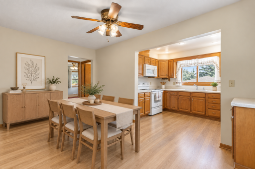 Virtually Staged - Past a Side Door to the Back Yard is This 14x8 ft Dining Room with Space for a Hutch and Seating for up to 8 at Your Table. Notice the Ceiling Fans in all but the Kitchen and Bath on the Main Level.