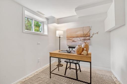 This flexible lower-level room makes an ideal home office, hobby space, quiet study area, or 4th bedroom