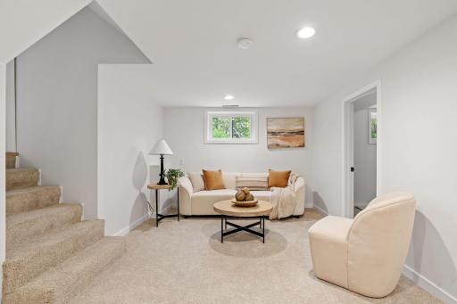 The finished lower-level family room offers a comfortable and versatile space for movie nights, recreation, or casual entertaining.