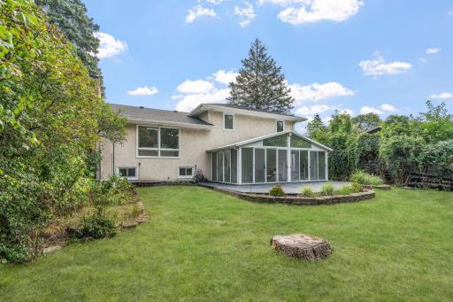 The spacious backyard offers plenty of room to relax, play, or entertain, while the screened porch provides a comfortable place to enjoy the outdoors.