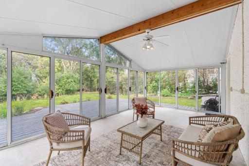 Surrounded by windows, the expansive screened porch offers a relaxing retreat with beautiful backyard views and plenty of room for entertaining.