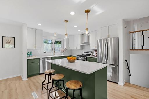 Photo for 1025 Colby Street, Saint Paul, MN 55116 - listing #7134206 e oversized center island provides abundant workspace and casual seating, while pendant lighting and extensive cabinetry complete this stylish kitchen.