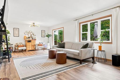 The large picture window fills the space with natural light, while contemporary lighting adds a stylish, modern touch. The patio door opens directly to a spacious entertaining deck. Creating an effortless flow between indoor & outdoor living.