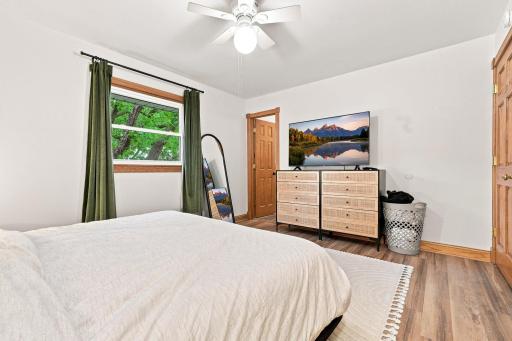 Retreat to a beautifully refreshed primary bedroom with a private bathroom, designed for comfort and easy living. Highlights: modern flooring, crisp new trim, six-panel oak doors, and a ceiling light/fan.