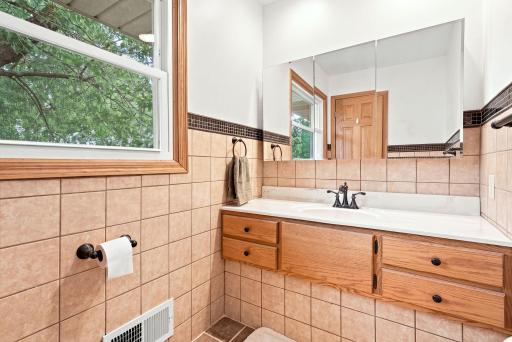 Convenient and private Primary bathroom with a large vanity.