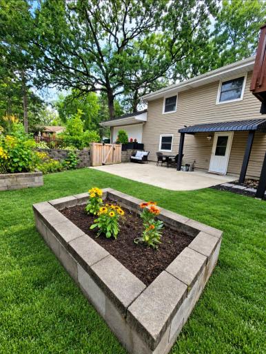 Early spring enhanced backyard with raised a garden bed