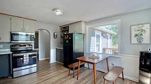 The charming, sun-lit kitchen offers a warm and welcoming ambiance.