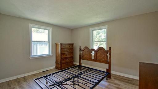 Generously sized primary bedroom on back left corner on the main level of home. This room offers beautiful views of the landscape to the north and west.