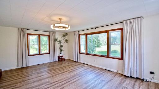 View of living room as you enter the home. Flooring has been recently updated with luxury vinyl planking throughout.