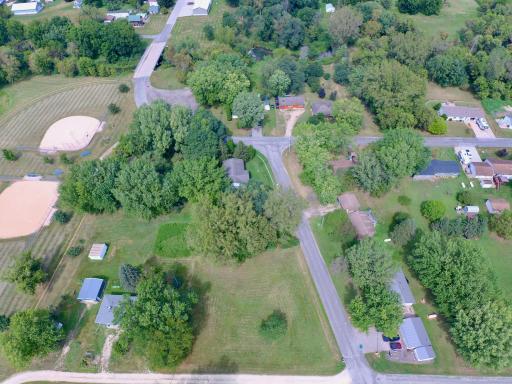Home is located in lower left corner. Old County Road 23 is on the right side. 10th Street is running across the bottom of the photo. Ralph Benicke Memorial Field is on the left and Garvin Brook goes under the bridge in the upper left of the photo.