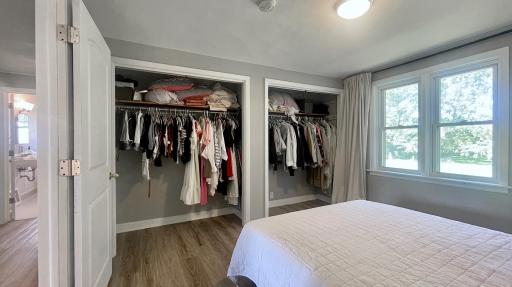 This bedroom is equipped with generously sized double closets designed for optimal storage.