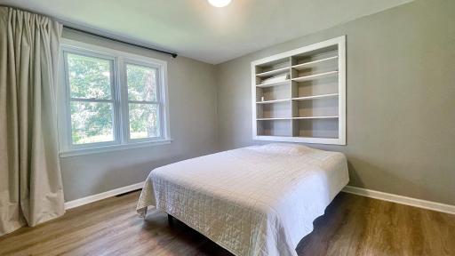 First bedroom down the hallway from the living room. Tailored built-in storage adds exceptional functionality and ease to the space.
