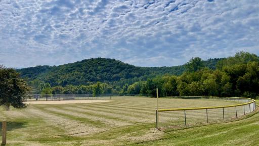 Take in classic small-town energy and breathtaking scenery with Ralph Benicke Memorial Field just past your yard, perfectly framed by rolling bluffs.